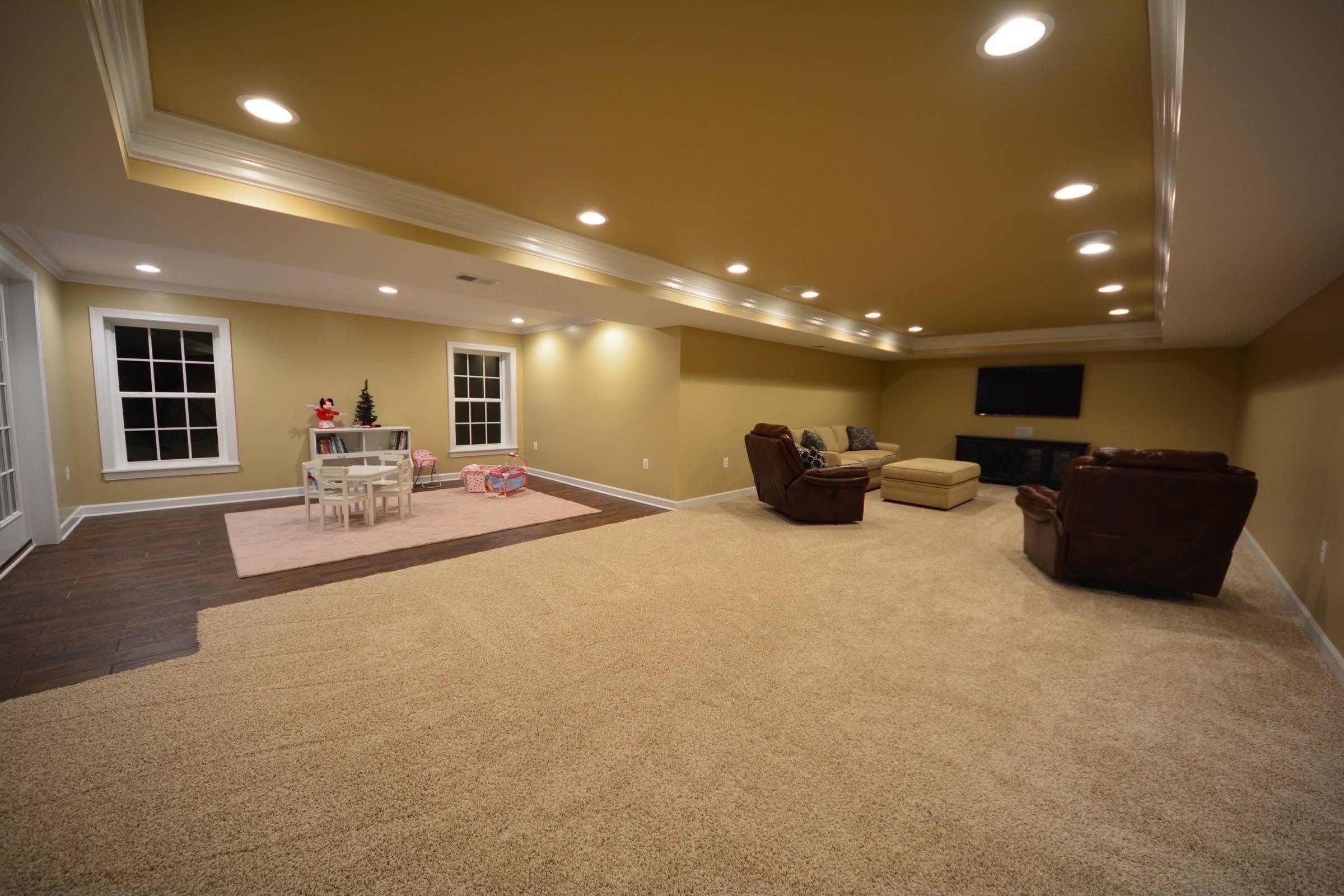 Large rectangular tray ceiling paired with an open-concept design and LED lighting