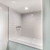 Renovated basement with a pet shower and tiled flooring