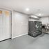 Renovated basement with a pet shower and tiled flooring