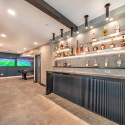 A complex basement finishing with movie theater, beautiful wet-bar/dry-bar and pool table area